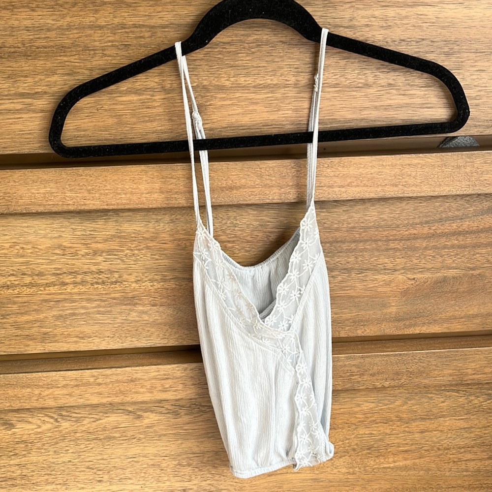 Light blue, spaghetti tank that crosses in the front